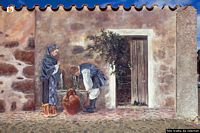 Abbasanta-Murale di Pina Monne in piazza della Vittoria: figura maschile e femminile alla fonte