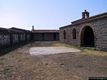 Dualchi: chiesa campestre di San Pietro: cortile con le <em>Cumbessias</em> Dualchi: chiesa campestre di San Pietro: cortile con le <em>Cumbessias</em>