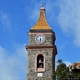 Gadoni-Chiesa parrocchiale della Beata Vergine Assunta: l&rsquo;imponente torre campanaria vista dal retro
