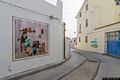 Girasole-Il murale che rappresenta un paesaggio con architettura e formiche