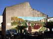 Montresta-Un murale sulle case del paese