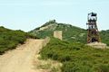 Sardara: il pozzo principale della miniera di Sardara con sullo sfondo il Castello di Monreale