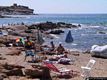 Alghero: il porto Ferro: scogli e spiaggia e sullo sfondo la Torre di Bantine ’e Sale