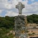 Scano di Montiferro-La croce in pietra su cippo lungo il sentiero per la tomba di giganti