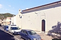 Siniscola-Santuario di Nostra Signora delle Grazie: fiancata sinistra con l’ingresso laterale ed il campanile a vela