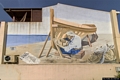 Stintino-Il murale che rappresenta una figura maschile che costruisce una barca Stintino-Il murale che rappresenta una figura maschile che costruisce una barca