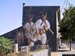 Tinnura-Un murale sulle case del paese