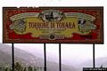 Tonara-Grande insegna di una ditta che produce torrone esposta all’ingresso dell’abitato